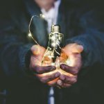 Industry Innovation - man holding incandescent bulb