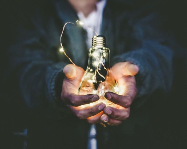 Industry Innovation - man holding incandescent bulb