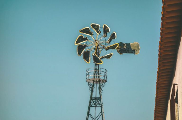 Setting Rates - blue and white windmill near white building