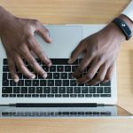 Professional Network - person's hand on MacBook near iPhone flat lay photography