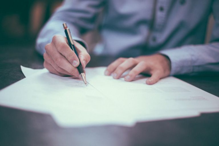Expanding Services - man writing on paper