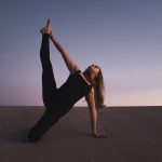 Flexibility Balance - woman holding her left leg high kneeling on floor