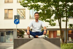 Freelancing Balance - man in white dress shirt sitting on gray concrete bench during daytime