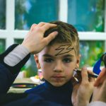 Creativity Leisure - a young boy is getting his hair cut