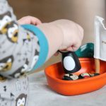 Ethical Implications - toddler playing plastic boat on mattress