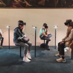 Virtual Reality - four person playing virtual reality goggles