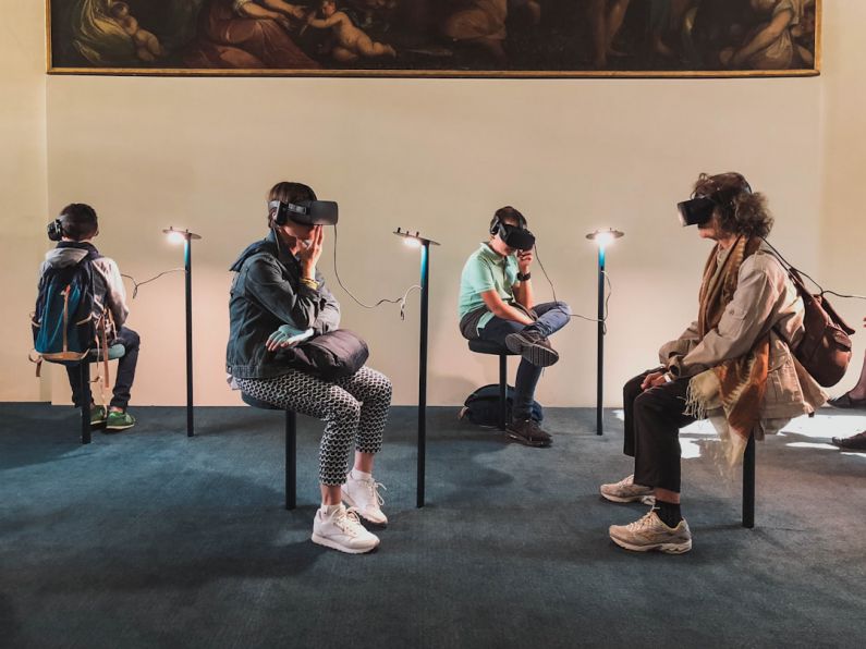 Virtual Reality - four person playing virtual reality goggles