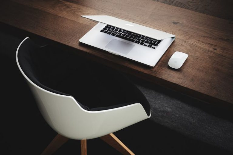 Gamification Work - Apple MacBook beside computer mouse on table