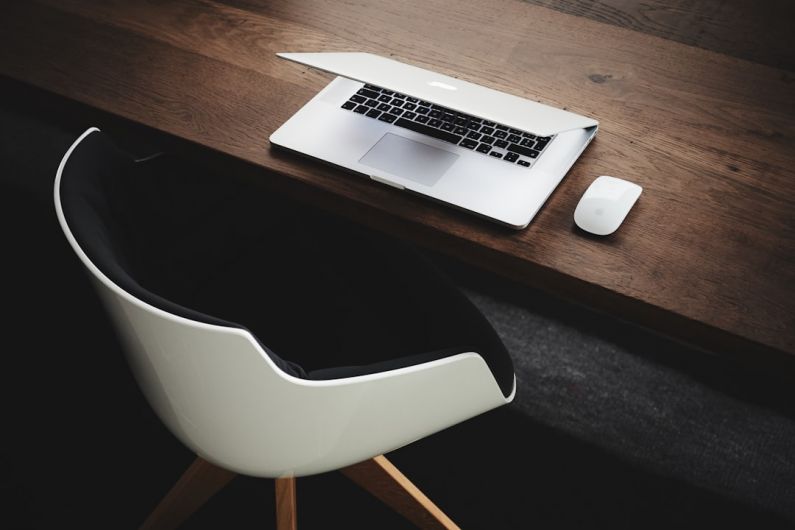 Gamification Work - Apple MacBook beside computer mouse on table