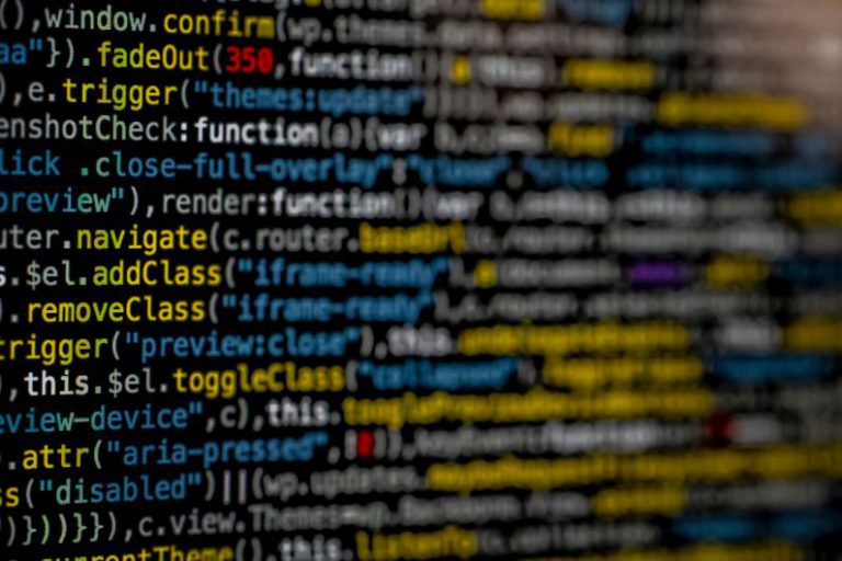 Cybersecurity Creative - yellow and blue data code displayed on screen