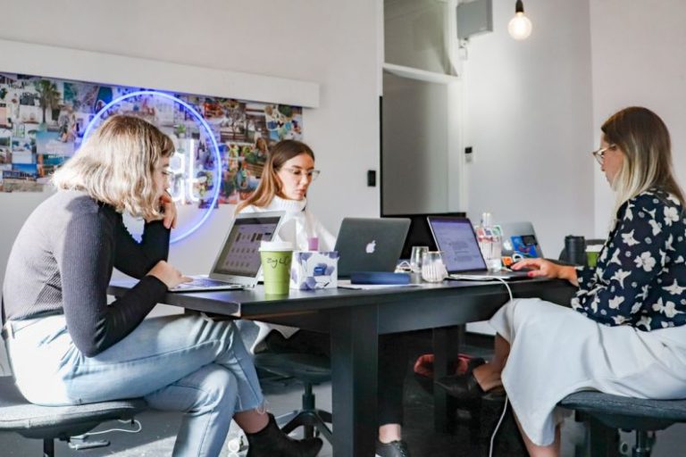 Tech Startup - 3 women sitting on chair in front of table with laptop computers