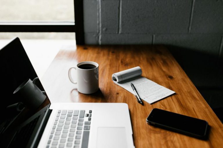 Job Trends - MacBook Pro, white ceramic mug,and black smartphone on table