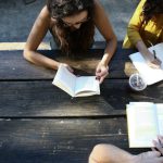 Education Innovation - woman reading book while sitting on chair