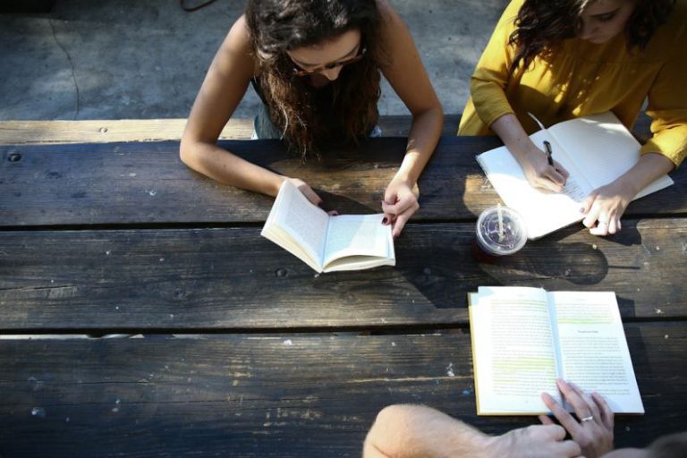 Education Innovation - woman reading book while sitting on chair