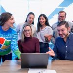 Networking Success - woman in maroon sweater using laptop