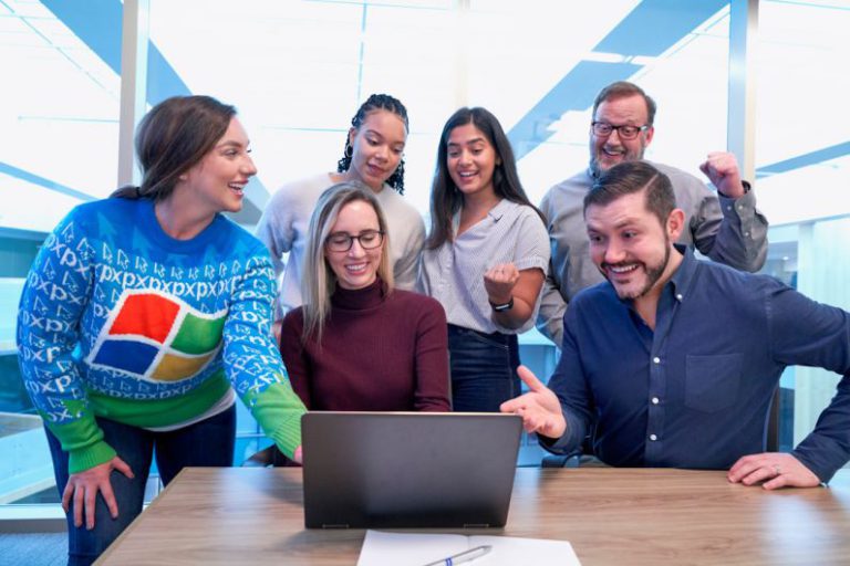 Networking Success - woman in maroon sweater using laptop