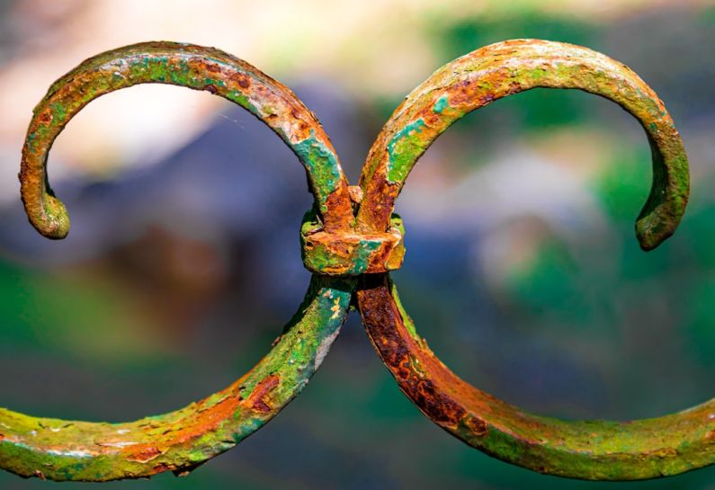 Hobby Business - a rusted iron gate with a curved design