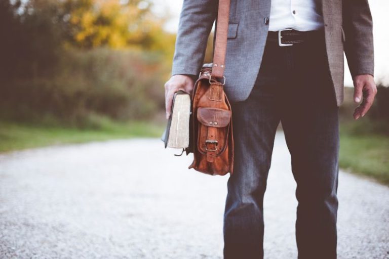 Career Path - man holding book on road during daytime