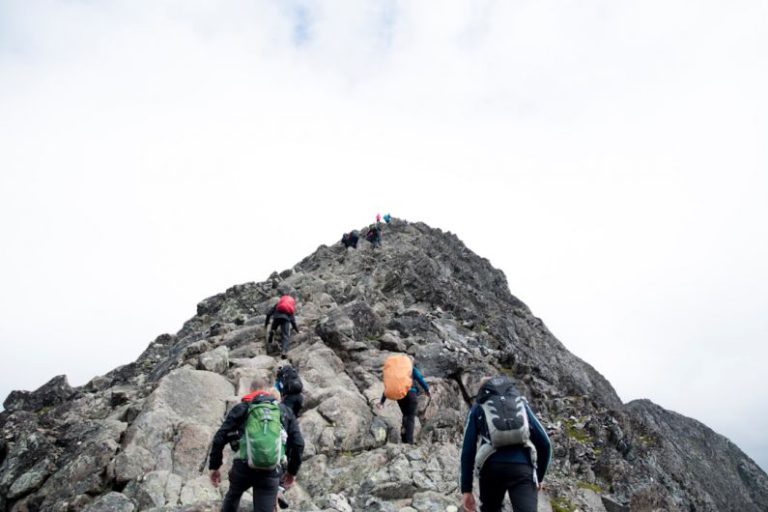 Leadership Development - climbers hiking through mountain peak during daytime