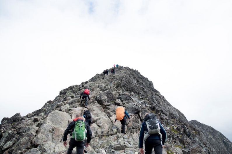 Leadership Development - climbers hiking through mountain peak during daytime