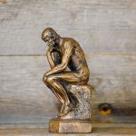 Critical Thinking - green ceramic statue of a man