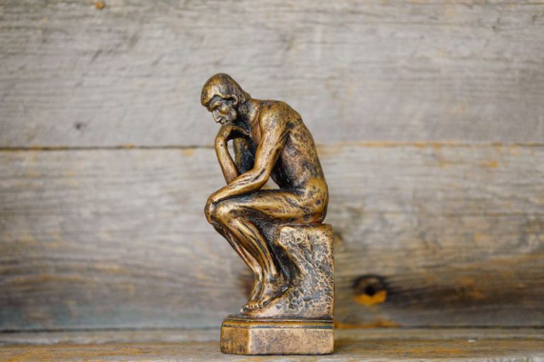 Critical Thinking - green ceramic statue of a man