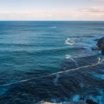 Resilience Success - a rope is attached to the edge of a cliff near the ocean