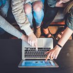 Online Communities - three person pointing the silver laptop computer