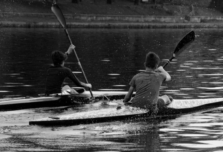 Competitors Collaborators - a couple of people riding on the back of a kayak