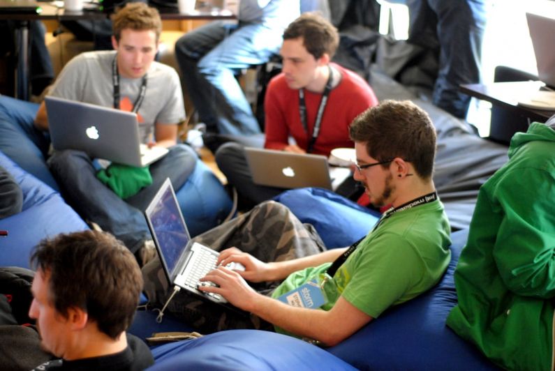 Peer Networking - man sitting on blue bean bag usinglaptop