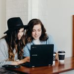 Networking Freelance - two woman sitting near table using Samsung laptop