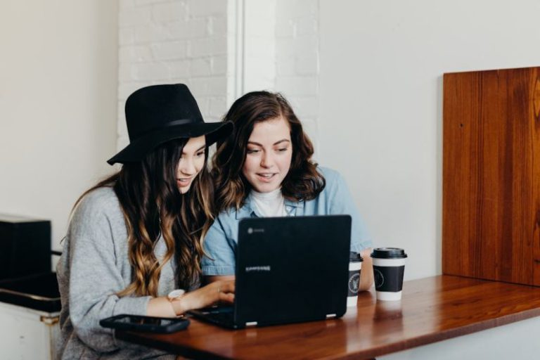 Networking Freelance - two woman sitting near table using Samsung laptop
