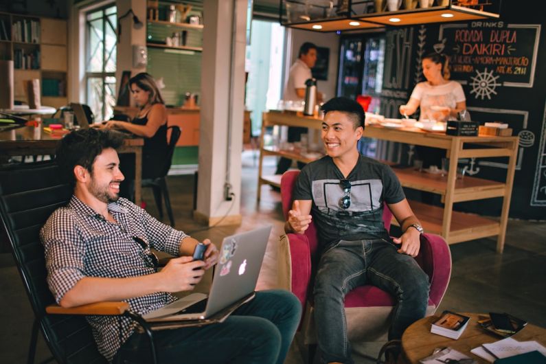 Introvert Networking - two men laughing white sitting on chairs
