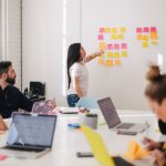 Global Networking - woman placing sticky notes on wall