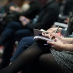 Networking Balance - selective focus photography of people sitting on chairs while writing on notebooks