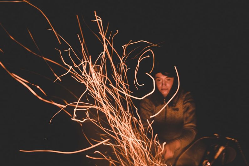 Storytelling Power - man in black jacket and black hat holding brown stick