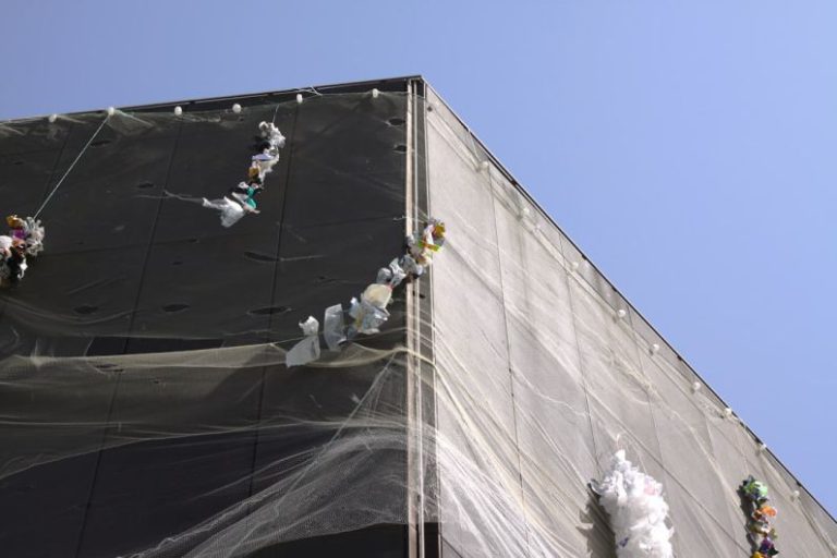 Adaptability Importance - a tall building with a net covering the top of it