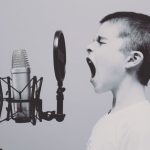 Presentation Skills - boy singing on microphone with pop filter