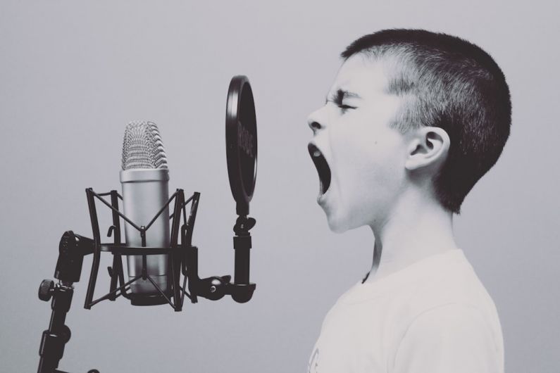 Presentation Skills - boy singing on microphone with pop filter