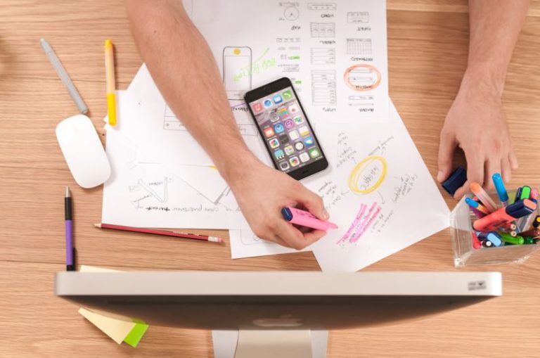 Marketing Budget - person writing on white paper