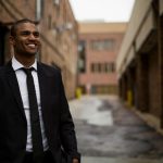 Networking Entrepreneurs - smiling man standing between brown concrete buildings at daytime