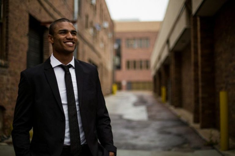 Networking Entrepreneurs - smiling man standing between brown concrete buildings at daytime